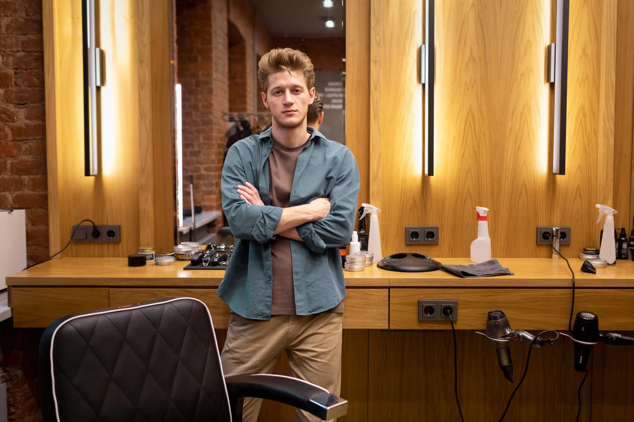 A salon owner looking over the styling floor of their salon